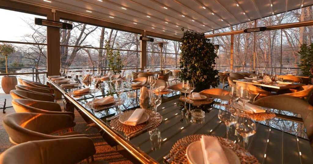 Outdoor dining table set with food and wine.