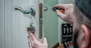 Locksmith fixing a door lock mechanism